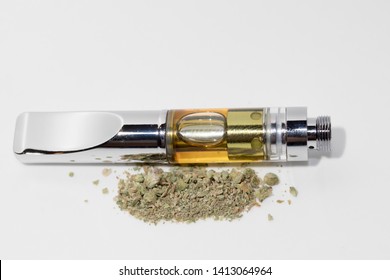 Vape Cartridge And Marijuana Bud On White Background. Vaping Cannabis With Dab Pen 