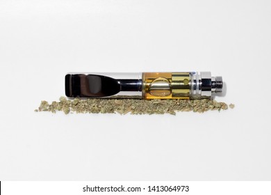 Vape Cartridge And Marijuana Bud On White Background. Vaping Cannabis With Dab Pen 