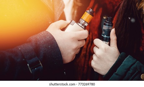 Vape. man and girl are smoking electronic cigarettes wape mod and drip. Banner
