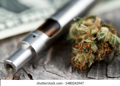 Vape Pen. Cannabis Marijuana Vaporizer. Medical Marijuana Bud with pen vaporizer close up image. CBD and THC vaping products. Vape CBD or THC Oil. Vaping Marijuana and Cannabis. Vaporizer 