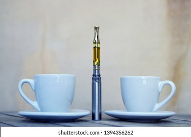 Vape Pen and Coffee Cup, Vaping THC and CBD, Cannabis and Marijuana Oil 