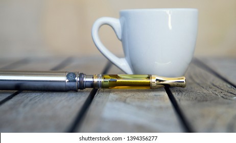 Vape Pen And Coffee Cup, Vaping THC And CBD, Cannabis And Marijuana Oil 