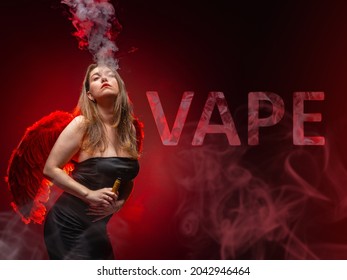 Vape Pen In Girl Hand. She Blows Steam Out Of Her Mouth. Vape Inscription Next To Vaper. Female Student With Vape Pen On Dark Red Background. She Is Wearing A Black Dress. Smoke From Vaping.