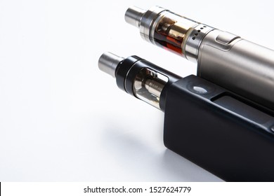 Vape. Vaping. Inventory For Vaper. Two Electronic Cigarettes Are Lying On The Table. Safe Smoking. Fighting A Bad Habit. Reduce Nicotine Intake. Vape Gadgets. Safe Cigarette. Smoking E-cigarettes.