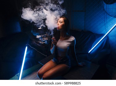 vaping concept, sexy woman smoking and vaping 