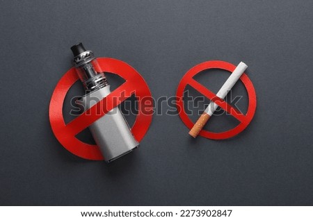 Vaping device and Cigarette with a prohibition sign on dark background. Smoking ban