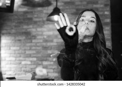 Vaping Teenager. Young Pretty White Girl Smoking An Electronic Cigarette  In Vape Bar. Bad Habit. Black And White.