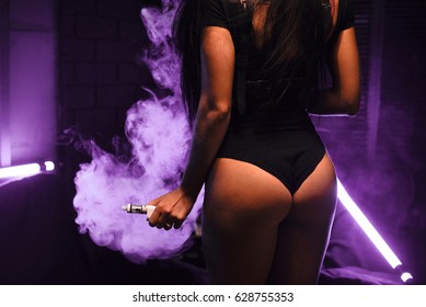 vapor concept,sexy young woman in lingerie vaping e-Cigarette