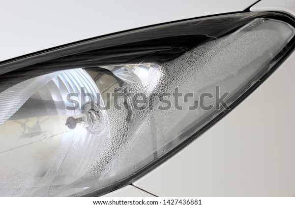 Vapor\
inside headlight of a car automotive\
background