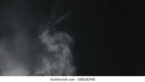 Vapor Steam Rising Over Black Background