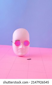 Vaporwave look made white face and gradient sunglasses   eyelashes against blue   pink grid background  Minimalistic retro futurism concept 