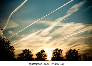 vapour trail . sky with lines of plane smoke. Sunset. Sunset Vapors