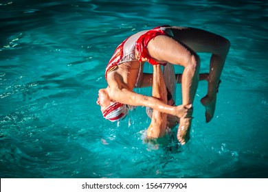 Varadero , Cuba, Jan 2013 - Water Ballet Duo Displaying Their Talent In The Pool At A Hotel Resort