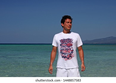 Varadero, Cuba - July 3, 2019: A Young Man With A Sweaty Face And A White Shirt With The Words 