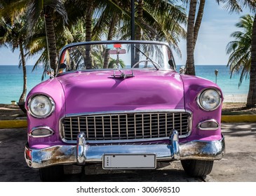 VARADERO, CUBA - JUNE 22, 2015: HDR pink american Oldtimer parked near the beach