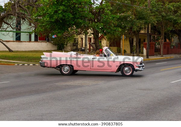 VARADERO, CUBA - MARCH 5: Pink and white vintage\
American car with huge fins driving on a street in Varadero, Cuba\
on March 5, 2016