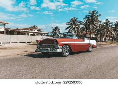 Varadero, Cuba. November 22, 2019: american Chevrolet Oldtimer rides on the road against the background of palm trees on the island of Cuba.