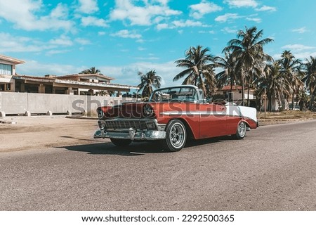 Varadero, Cuba. November 22, 2019: american Chevrolet Oldtimer rides on the road against the background of palm trees on the island of Cuba.