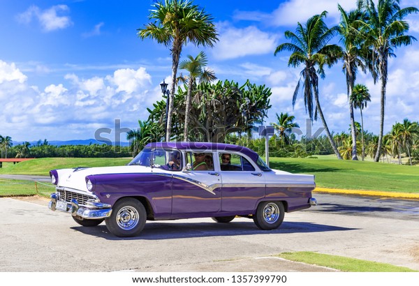 Varadero, Cuba - September 28, 2018: Cuban\
family drive in a american blue white 1956 Ford Fairlane vintage\
car in Varadero Cuba - Serie Cuba\
Reportage