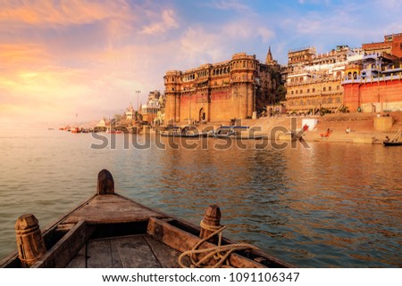 Varanasi ancient city architecture at sunset as viewed from a boat on river Ganges.