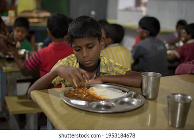 Varanasi, India. 10-14-2019. A Sad Boy Is Eating By His Own At The School Restaurant After Morning Class.