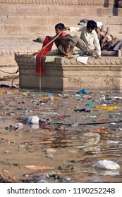 Varanasi. India. 10.16.06. Indian Boys Playing On The Hindu Ghats Among The Pollution In The Holy River Ganges. Varanasi In The Uttar Pradesh Region Of Northern India