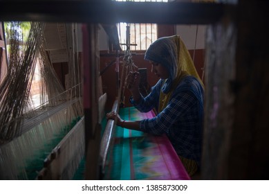 Varanasi / India 24 April 2019 Muslim Girl Weaving A Banarasi Saree On Her Handloom At Village In Varanasi Uttar Pradesh