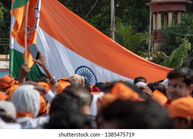 Varanasi / India 25 April 2019 Bharatiya Janata Party (BJP) Supporters Wave Indian National Flag During A Roadshow By PM Narendra Modi In Varanasi Uttar Pradesh