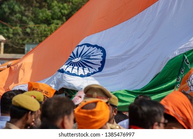 Varanasi / India 25 April 2019 Bharatiya Janata Party (BJP) Supporters Wave Indian National Flag During A Roadshow By PM Narendra Modi In Varanasi Uttar Pradesh