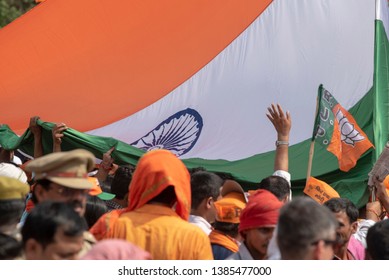 Varanasi / India 25 April 2019 Bharatiya Janata Party (BJP) Supporters Wave Indian National Flag During A Roadshow By PM Narendra Modi In Varanasi Uttar Pradesh