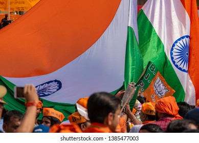 Varanasi / India 25 April 2019 Bharatiya Janata Party (BJP) Supporters Wave Indian National Flag During A Roadshow By PM Narendra Modi In Varanasi Uttar Pradesh