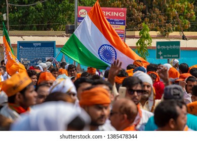 Varanasi / India 25 April 2019 Bharatiya Janata Party (BJP) Supporters Wave Indian National Flag During A Roadshow By PM Narendra Modi In Varanasi Uttar Pradesh