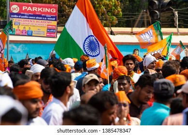 Varanasi / India 25 April 2019 Bharatiya Janata Party (BJP) Supporters Wave Indian National Flag During A Roadshow By PM Narendra Modi In Varanasi Uttar Pradesh