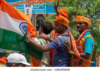 Varanasi / India 25 April 2019 Bharatiya Janata Party (BJP) Supporters Wave Indian National Flag During A Roadshow By PM Narendra Modi In Varanasi Uttar Pradesh