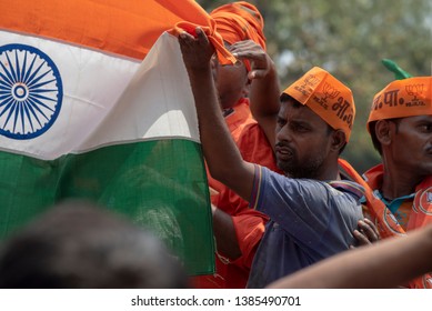 Varanasi / India 25 April 2019 Bharatiya Janata Party (BJP) Supporters Wave Indian National Flag During A Roadshow By PM Narendra Modi In Varanasi Uttar Pradesh