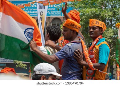 Varanasi / India 25 April 2019 Bharatiya Janata Party (BJP) Supporters Wave Indian National Flag During A Roadshow By PM Narendra Modi In Varanasi Uttar Pradesh