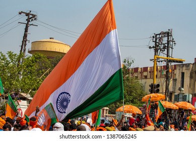 Varanasi / India 25 April 2019 Bharatiya Janata Party (BJP) Supporters Wave Indian National Flag During A Roadshow By PM Narendra Modi In Varanasi Uttar Pradesh