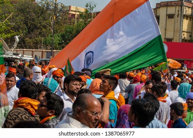 Varanasi / India 25 April 2019 Bharatiya Janata Party (BJP) Supporters Wave Indian National Flag During Lok Sabha Electionsin Varanasi Uttar Pradesh