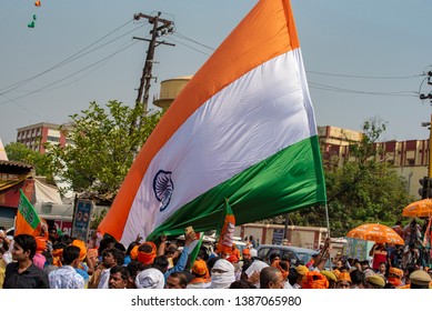 Varanasi / India 25 April 2019 Bharatiya Janata Party (BJP) Supporters Wave Indian National Flag During Lok Sabha Electionsin Varanasi Uttar Pradesh