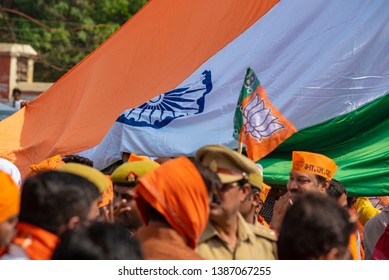 Varanasi / India 25 April 2019 Bharatiya Janata Party (BJP) Supporters Wave Indian National Flag During Lok Sabha Elections In Varanasi Uttar Pradesh