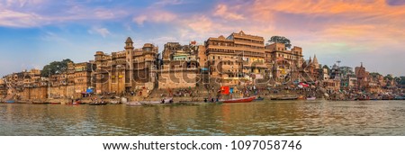 Varanasi India ancient city architecture panoramic view at sunset as seen from a boat on river Ganges.