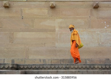 VARANASI, INDIA - AUG 23, 2015. Shaiva sadhu seeking alms on the street in Varanasi, India. Varanasi is a city dating to the 11th century B.C.E, the spiritual capital of India.