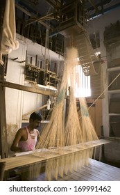 VARANASI, INDIA - DEC 9: Unidentified Man Makes A Traditional Sari Cloth, Hand Loom On Old Fabric Factory On Dec 9, 2013 In Varanasi, India. Textile Industry In Varanasi Preserved Ancient Traditions