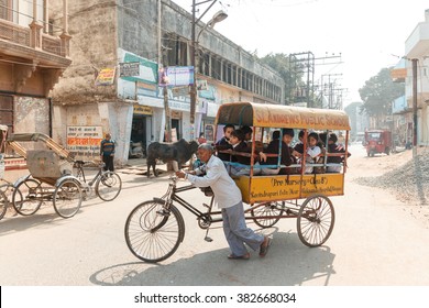 VARANASI, INDIA - DECEMBER 1: Unidentified Cycle rickshaw carries unidentified children to school on December 1, 2012 in Varanasi. Cycle rickshaws are widely used in cities of India.