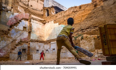 VARANASI, INDIA, FEBRUARY 14, 2017: Many Young Children Are Playing Cricket In Every Street Corner In Varanasi, India.