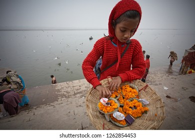 Varanasi, India, January 2009. A Girl Selling Flowers In A Ghat On The Ganges River.