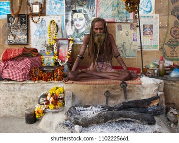 VARANASI, INDIA - JANUARY 2018: Indian naked Sadhu in meditation position in the holy city of Varanasi, India