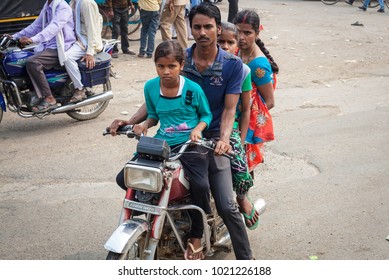 VARANASI, INDIA - OCTOBER 28:  Young Famile Riding On A Bike. Motorbike Is The Most Favorite Vehicle And Most Affordable For India.