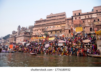 Varanasi, India/November 23, 2018: Pilgrims take a holy dip at Ahilyabai Ghat which is on the River Ganges during Kartik Purnima in Varanasi, Banaras, Kashi, Uttar Pradesh, India.