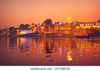 VARANASI, UTTAR PRADESH / INDIA - JANUARY 8, 2019: People Walk Along Ghats Of Ganges River At Night